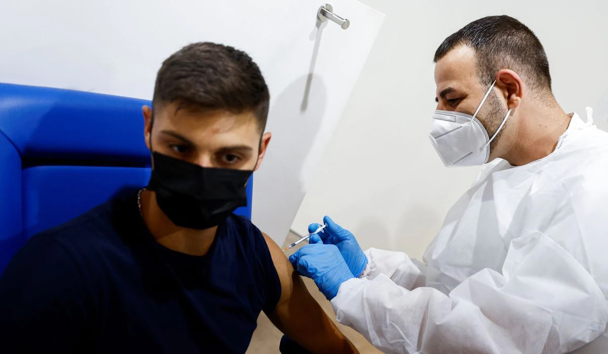 A man receives a dose of the Moderna vaccine in Italy